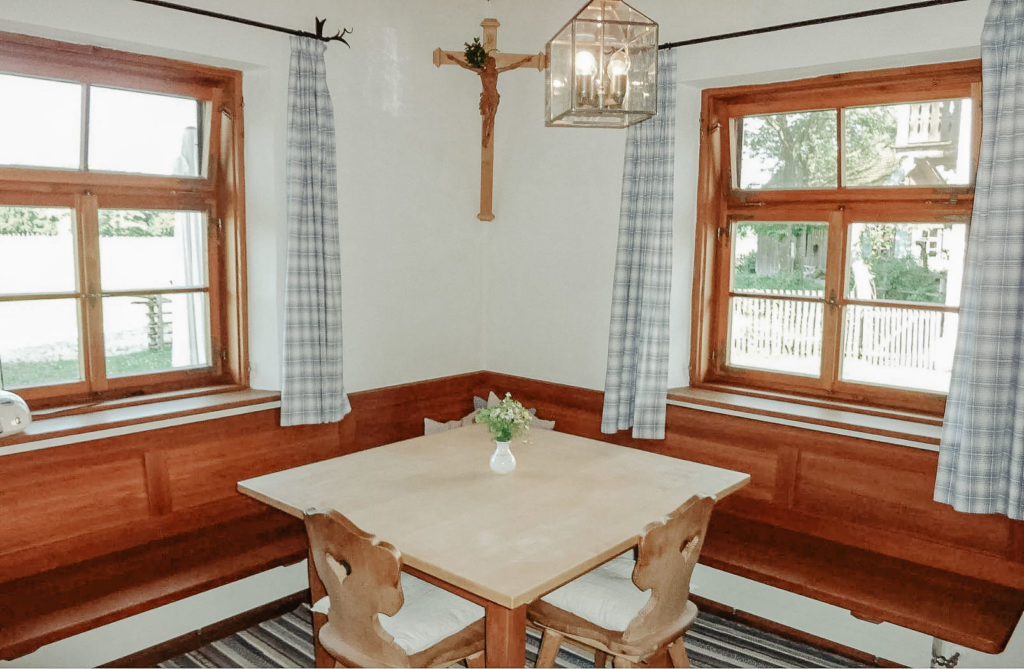 Das gemütliche Esszimmer der Ferienwohnung mit einer Eckbank, einem Tisch und Stühlen aus Holz